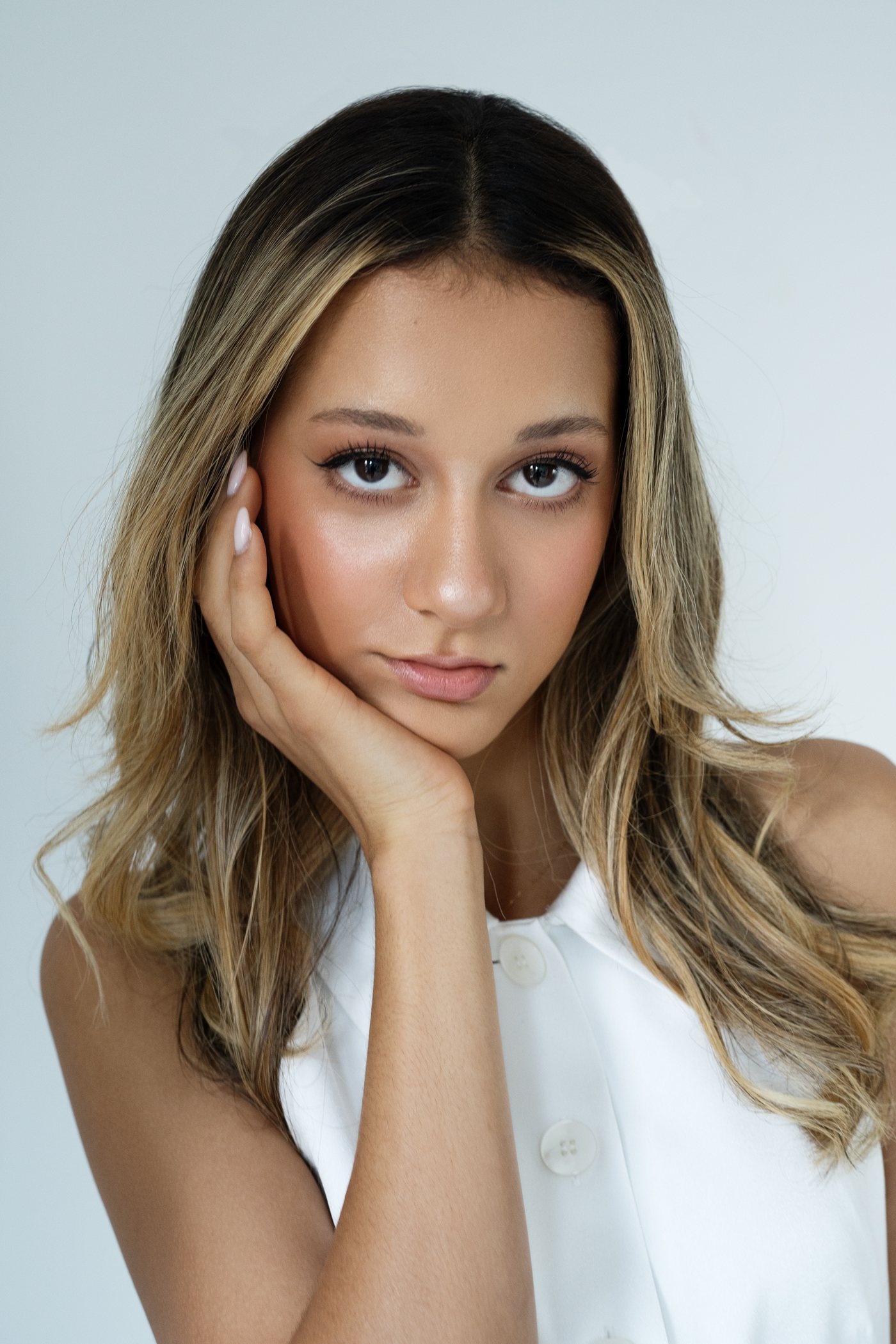 Beauty portrait on white, hand to face